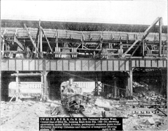 Plate XLIX, Fig. 3.— TW 88, P.T. & T.R.R. Co. N.R. Div. Terminal Station West. Center line of 32nd St., looking East from Sta. 183+50, showing excavation under Ninth Avenue, permanent concrete piers under Elevated Railway Columns and removal of temporary shoring girders "C". April 8, 09.