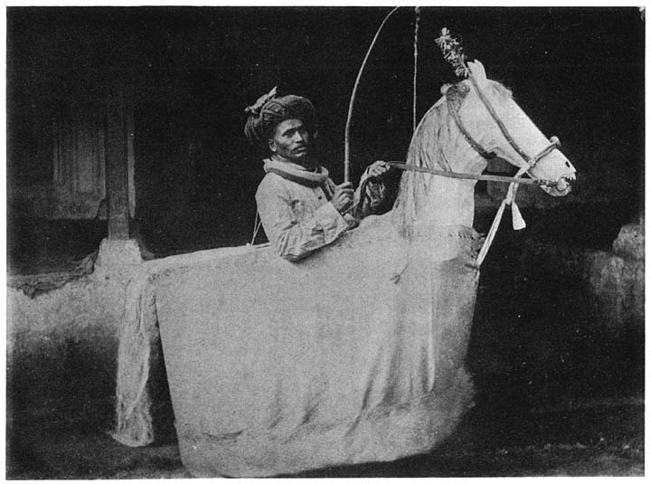 Beggar on artificial horse at the Muharram festival