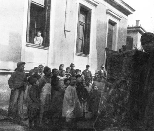 GREEK CHILDREN WERE GROUPED AROUND A PUNCH AND
JUDY SHOW.