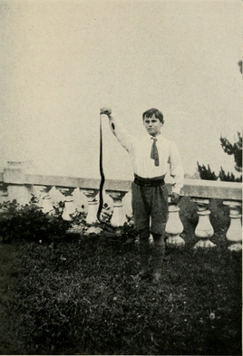 DENIS WITH A BLACK SNAKE AT MEDLOW BATH.